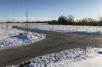 a picture of the snow on the road is clear and there is a white building in the distance