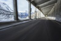 a blurry image of a road in an tunnel with rain, as viewed from the front seat of a car