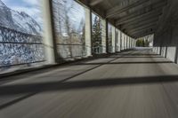 a blurry image of a road in an tunnel with rain, as viewed from the front seat of a car