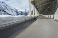 a blurry image of a road in an tunnel with rain, as viewed from the front seat of a car