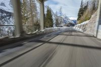 a blurry image of a road in an tunnel with rain, as viewed from the front seat of a car