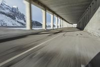 a blurry image of a road in an tunnel with rain, as viewed from the front seat of a car