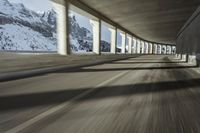 a blurry image of a road in an tunnel with rain, as viewed from the front seat of a car