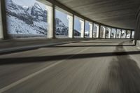 a blurry image of a road in an tunnel with rain, as viewed from the front seat of a car