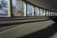 a blurry image of a road in an tunnel with rain, as viewed from the front seat of a car