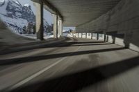 a blurry image of a road in an tunnel with rain, as viewed from the front seat of a car