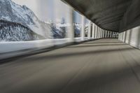 a blurry image of a road in an tunnel with rain, as viewed from the front seat of a car