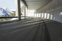 a blurry image of a road in an tunnel with rain, as viewed from the front seat of a car