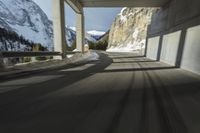 a blurry image of a road in an tunnel with rain, as viewed from the front seat of a car