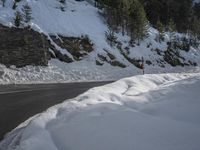 the road is closed to traffic on a snowy mountain side area that has no cars on it