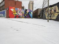 Winter Urban Scene in Detroit: Graffiti Wall and Snow-Covered Road
