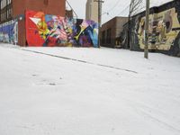 Winter Urban Scene in Detroit: Graffiti Wall and Snow-Covered Road