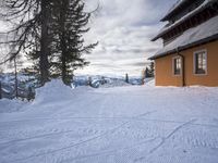a building has been covered in some snow on the mountain side for the skiers to ski