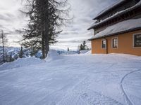 a building has been covered in some snow on the mountain side for the skiers to ski