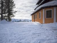 a building has been covered in some snow on the mountain side for the skiers to ski