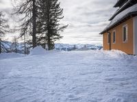 a building has been covered in some snow on the mountain side for the skiers to ski