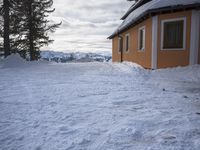 a building has been covered in some snow on the mountain side for the skiers to ski