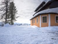 a building has been covered in some snow on the mountain side for the skiers to ski