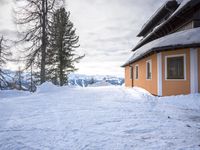 a building has been covered in some snow on the mountain side for the skiers to ski