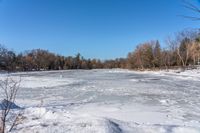 a wide angle view of a snow covered lake with lots of snow in front of it