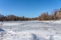 a wide angle view of a snow covered lake with lots of snow in front of it