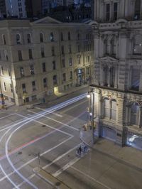 an empty city street at night as seen from a high angle view of the building