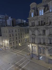 an empty city street at night as seen from a high angle view of the building