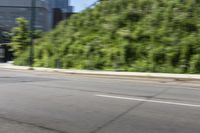 a woman riding a bicycle in an empty city road, while another one wears an oxygen vest