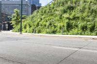 a woman riding a bicycle in an empty city road, while another one wears an oxygen vest