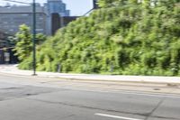 a woman riding a bicycle in an empty city road, while another one wears an oxygen vest