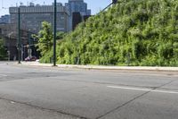 a woman riding a bicycle in an empty city road, while another one wears an oxygen vest