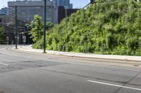 a woman riding a bicycle in an empty city road, while another one wears an oxygen vest