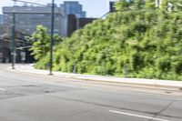 a woman riding a bicycle in an empty city road, while another one wears an oxygen vest