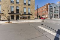 a woman is riding a bicycle by a building and a street sign for a liquor store