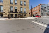 a woman is riding a bicycle by a building and a street sign for a liquor store