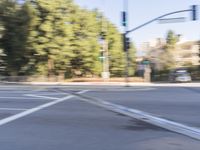 a woman rides a motorcycle in a motion on the side of the street with tall buildings