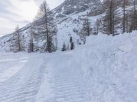 a woman riding skis down the side of a snow covered mountain road at high speed