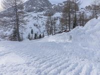 a woman riding skis down the side of a snow covered mountain road at high speed