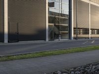 a woman is sitting on a bench while talking on her cellphone outside a building