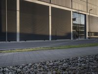 a woman is sitting on a bench while talking on her cellphone outside a building