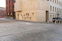 the woman is holding an umbrella and walking down the road to the storefront of this building