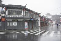 a woman walks through an alley in the rain holding an umbrella on a rainy day