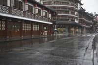 a woman walks through an alley in the rain holding an umbrella on a rainy day