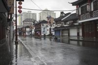 a woman walks through an alley in the rain holding an umbrella on a rainy day