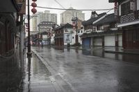 a woman walks through an alley in the rain holding an umbrella on a rainy day