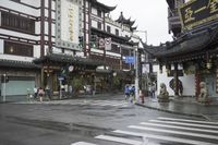 a woman walks through an alley in the rain holding an umbrella on a rainy day