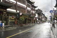 a woman walks through an alley in the rain holding an umbrella on a rainy day