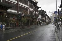 a woman walks through an alley in the rain holding an umbrella on a rainy day