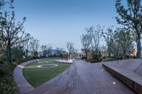 a wooden deck that is next to a fountain in the water area of a park