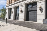 a building with a wooden floor and two gray doors with brown trims that look to be front